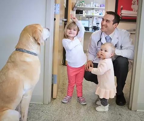 Veterinarian with two children and a dog